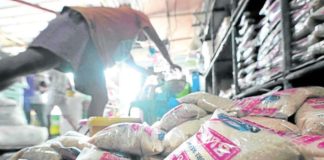 A worker repacks sugar at the Visayas Avenue public market. The Philippines may allocate all its sugar for domestic consumption as local production remains insufficient to meet the demand. GRIG C. MONTEGRANDE/INQUIRER.NET PHOTO