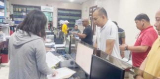 Retired Police Major Charlie Sustento Jr. (left) submits his letter request to the local government unit of Dumangas, Iloilo for copies of documents regarding the operations of Dumangas Port on Tuesday, August 27.