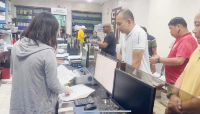 sustento_pic_resized Retired Police Major Charlie Sustento Jr. (left) submits his letter request to the local government unit of Dumangas, Iloilo for copies of documents regarding the operations of Dumangas Port on Tuesday, August 27.