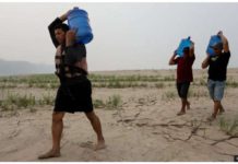 Drought leaves Amazon basin rivers at all-time low People carry drinking water along a sandbank of Madeira River in Paraizinho Community, in Humaita, Amazonas state, northern Brazil. Rivers are dying up. GETTY IMAGES