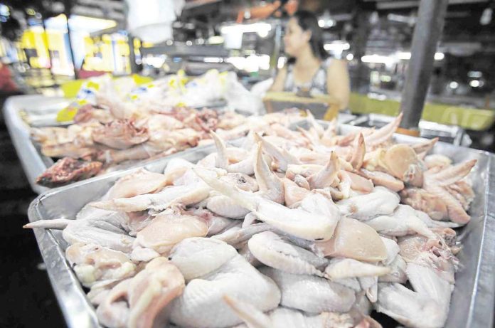 DA_bans_resized The Department of Agriculture temporarily bans the entry of poultry imports from France due to a bird flu outbreak at the European country. Photo shows a vendor tending to her store at a public market in Manila. INQUIRER.NET STOCK IMAGES