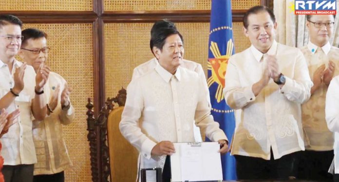 President Ferdinand R. Marcos Jr. holds the Magna Carta of Filipino Seafarers that he signed into law, honoring the sacrifices of overseas seafarers and their significant contributions to economic growth. He emphasizes the importance of the new law which aims to uphold the fundamental rights of seafarers. PCO