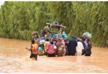 Floods force Niger to delay new school year People wading through floodwaters water in Niger. AFP