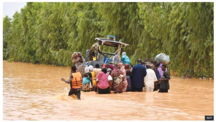 Niger_resized People wading through floodwaters water in Niger. AFP