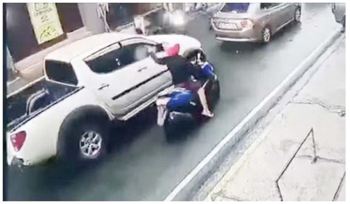PNP-1 This screenshot from a closed circuit television footage shows a motorcycle-riding gunman firing shots at the vehicle of Philippine Charity Sweepstakes Office’s Board Secretary Wesley Barayuga in Mandaluyong City in July 2020. Screenshot provided by the Mandaluyong City PNP