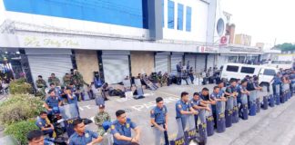 Anti-riot police position themselves along the road facing the Jose Maria College, located inside the Kingdom of Jesus Christ compound, in Buhangin District, Davao City. Police officers keep the peace as the search for fugitive Pastor Apollo Quiboloy. PNA