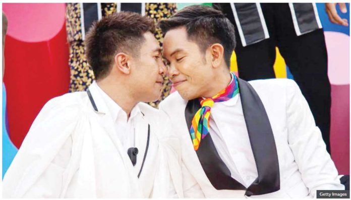 Thailand_1_resized A gay couple - two men - sit close together with their heads touching as they pose for a photo during a celebration hosted by the Thai government to mark the passage of the marriage equality bill. Gay couples in Thailand can register their unions from January 22 next year. GETTY IMAGES