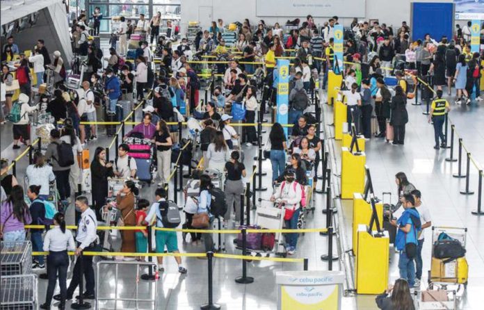cheaper_flights Outbound travelers queue at the Ninoy Aquino International Airport Terminal 3 check-in and immigration counters. MARIA TAN/ABS-CBN NEWS PHOTO