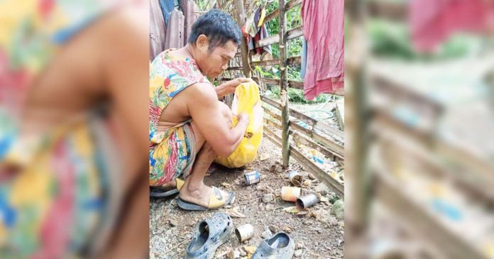 dengue-antique A resident of Barangay Codiong, Libertad, Antique eliminates mosquito breeding sites such as empty tin cans. BARANGAY CODIONG, LIBERTAD/FACEBOOK PHOTO