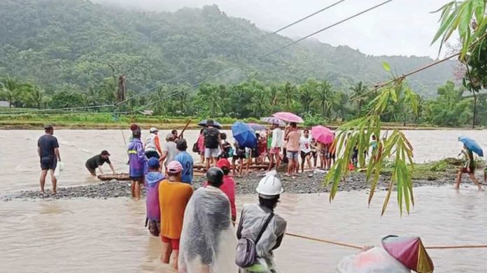 Due to heavy rains, rising waters in Ypayo River in Patnongon, Antique prompted authorities to prohibit students and local residents from crossing. Stranded individuals sought temporary refuge at Igburi National High School. PHOTO COURTESY OF THE MUNICIPALITY OF PATNONGON/FB