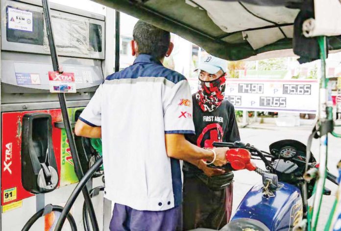 fuel_prices_1_resized A gasoline station clerk refills a tricycle’s tank at a station in Manila. GEORGE CALVELO/ABS-CBN NEWS FILE PHOTO
