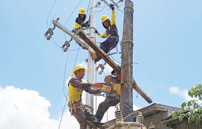 ileco-1 The Iloilo Electric Cooperative 1, Inc. (ILECO 1) explained that the major factor that caused the increase in the electric bills for July and August this year was the National Grid Corp. of the Philippines’ line rental increase. Photo shows ILECO 1 personnel doing maintenance work. ILECO 1 FILE PHOTO