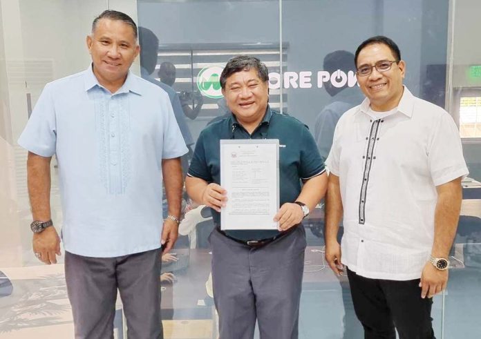 Sangguniang Bayan members Dan Fajardo (right) and Pyt Trimañez (left) of Pavia, Iloilo handed Resolution No. 2024-140 to MORE Electric and Power Corporation (MORE Power) president and chief executive officer R. Roel Z. Castro (center).