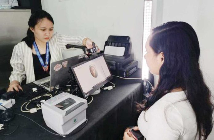 national_ID A registration officer captures the client's front-facing image as a requirement for generating the digital national ID. PSA-AKLAN PHOTO