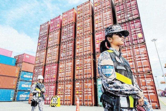 rice_containers_resized Port officers guard containers of imported rice ahead of an inspection by Philippine Ports Authority officials of a warehouse at the Port of Manila on Sept. 21, 2024. RYAN BALDEMOR/PHILSTAR.COM PHOTO
