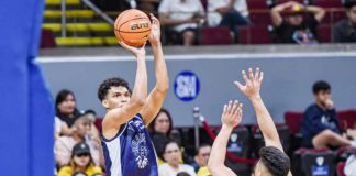 Adamson University Falcons’ Anthony Fransman shoots over the defense of University of Santo Tomas Growling Tigers’ Miguel Pangilinan. UAAP PHOTO