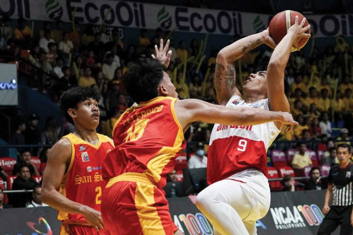 sports-Ilonggo Ilonggo John Bryan Sajonia of San Beda University Red Lions attacks two San Sebastian College Golden Stags’ defenders. PHOTO COURTESY OF NCAA/GMA SPORTS