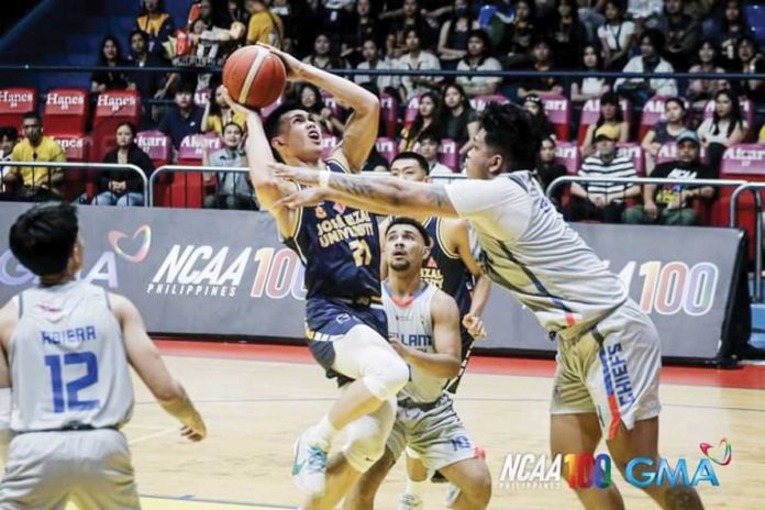 sports-JRU Negrense Lance Benitez of Jose Rizal University Heavy Bombers tries to score against an Arellano University Chiefs defender. PHOTO COURTESY OF NCAA/GMA SPORTS