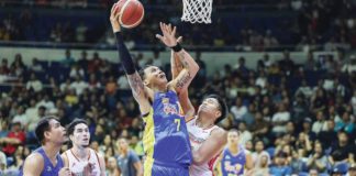 TNT Tropang Giga’s John Paul Erram scores against the defense of NorthPort Batang Pier’s Damie Cuntapay. PBA PHOTO
