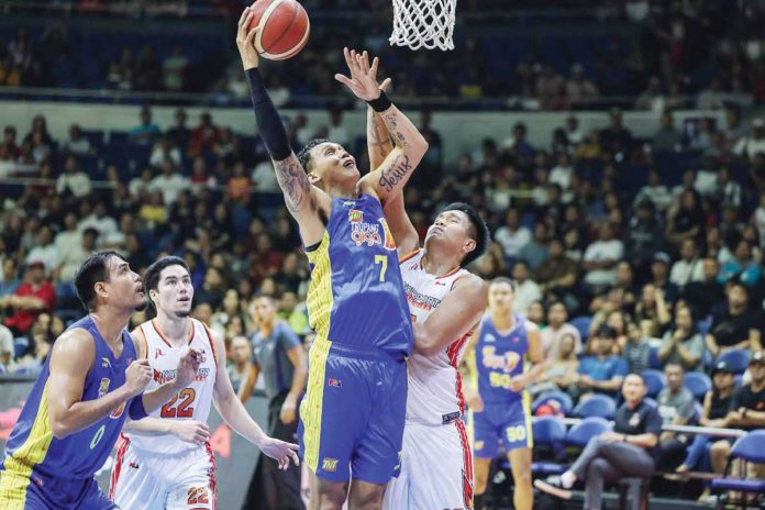 sports-PBA TNT Tropang Giga’s John Paul Erram scores against the defense of NorthPort Batang Pier’s Damie Cuntapay. PBA PHOTO