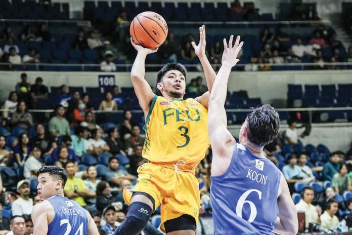 sports_Bautista_resized Far Eastern University Tamaraws’ Jorick Bautista goes for a one-hander against the defense of Ateneo de Manila University Blue Eagles’ Chris Koon. UAAP PHOTO