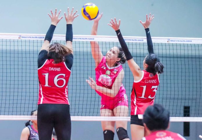 sports_Biñan_1_resized Negrense Erika Jin Deloria of Biñan Tatak Gel 1-Pacman Partylist Volley Angels smashes the ball against two defenders. MPVA PHOTO