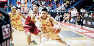 Mapua University Cardinals’ Clint Escamis wards off a University of Perpetual Help Altas’ defender. PHOTO COURTESY OF NCAA/GMA SPORTS