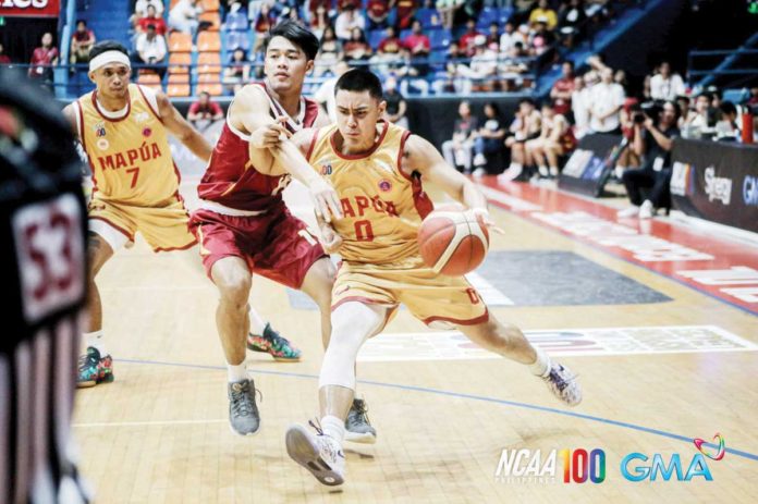 sports_Escamis_resized Mapua University Cardinals’ Clint Escamis wards off a University of Perpetual Help Altas’ defender. PHOTO COURTESY OF NCAA/GMA SPORTS