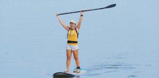 Ilongga influencer Lucy Lynette Ponce Uygongco, 54, rejoices by raising her paddle after arriving at Pasil Sandbar in Brgy. Latasan, EB Magalona, Negros Occidental.