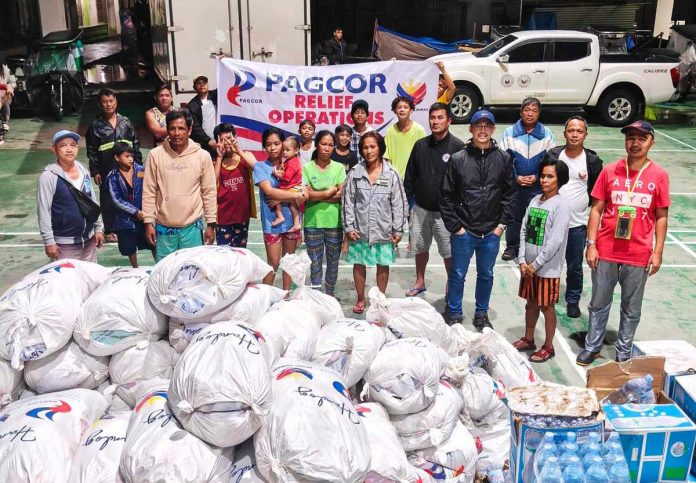 2Photo-1 Evacuees sheltering at the TM Kalaw Elementary School and Cipriano Andal Memorial Elementary School in Lipa City receive food and non-food packs from PAGCOR at the height of Tropical Storm Kristine’s onslaught.