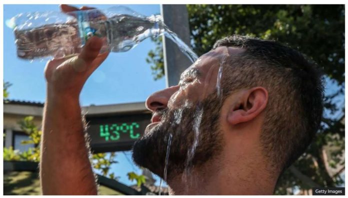 Geneva_resized A man pours water over his head to cool down. Little progress has been made in limiting emissions of greenhouse gases that are driving up temperatures. GETTY IMAGES