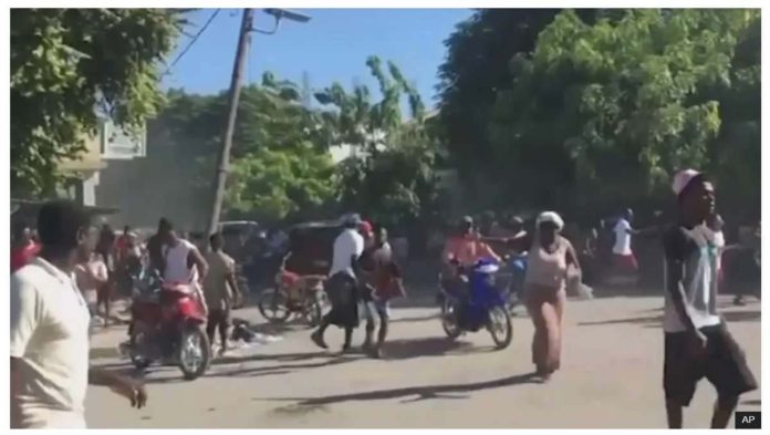 Haiti_resized_resized People could be seen fleeing violence on motorbikes and on foot in Haiti. AP