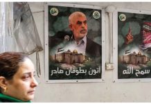 Yahya Sinwar, leader of Hamas, killed by Israel A woman walks past posters depicting Yahya Sinwar (left) in the Gaza Strip. Sinwar was the leader of Hamas. GETTY IMAGES