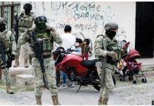 Five beheaded bodies found in Mexico Four Mexican army soldiers stand guard. They are armed with assault rifles, as well as wearing full military gear and facemask. GETTY IMAGES