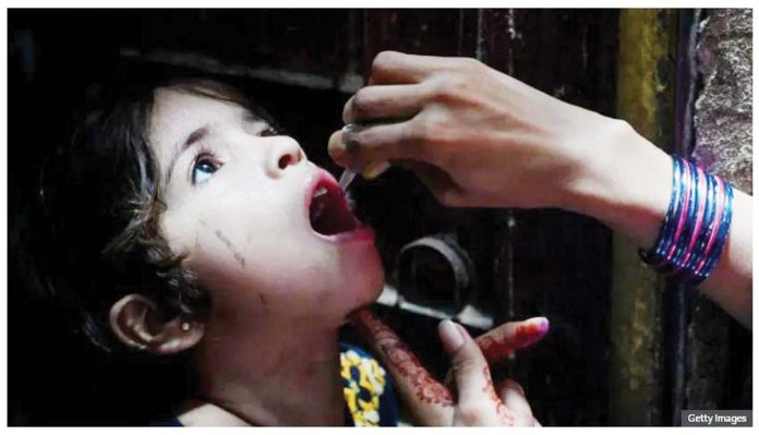 Pakistan-1 A health worker administers polio vaccine drops to a young girl during a polio vaccination campaign in Karachi, Pakistan. Pakistani officials are preparing to launch a nationwide vaccination campaign for children under five. GETTY IMAGES