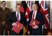 UK, Germany sign ‘landmark’ defense agreement United Kingdom’s Defence Secretary John Healey and Germany’s Defence Minister Boris Pistorius smile, standing in front of the Union Jack and German flags, holding red binders. BBC