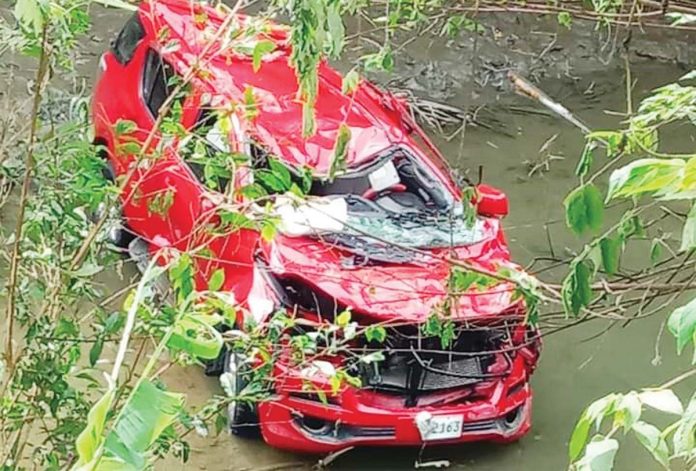 This sport utility vehicle plunged off a bridge into a river in Barangay Arobo, Tobias Fornier, Antique on Friday night, Oct. 18, 2024, killing a 40-year-old driver. His wife was injured, police said. RAMBO IBAÑEZ HUERRA III/FACEBOOK PHOTO