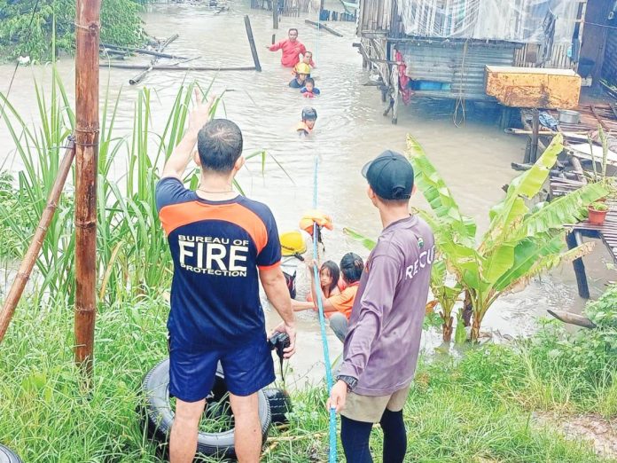 bacolod flooding Personnel of the Bureau of Fire Protection (BFP) – Bacolod City rescued families affected by flooding in Bag-ong Dalan, Barangay Sum-ag on Monday morning, October 21, 2024. BFP-BACOLOD CITY PHOTO