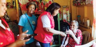 Remedios Chavez (right) receives a walking cane from Mayor Raymund Tongson for her 89th birthday. Photo also shows senior citizens focal person Norma Pelayo (second from right) of the Himamaylan City Social Welfare and Development Office handing over the cane to Chavez. CITY GOVERNMENT OF HIMAMAYLAN PHOTO