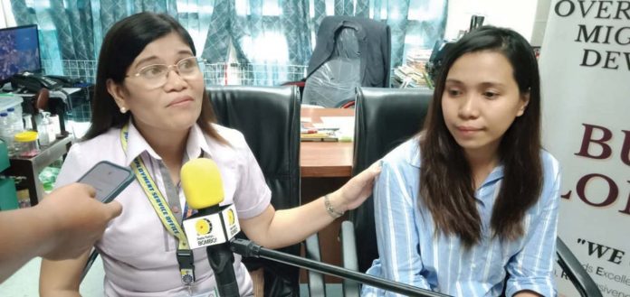 Iloilo Public Employment Service Office acting head Cynthia Parcon-Dario (left) consoles repatriated overseas Filipino worker Donna Jean Gabasa-Berniz from Lebanon.