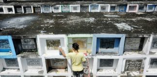 REMEMBERING DEPARTED LOVED ONES. It is a tradition for families to visit cemeteries on Nov. 1 and Nov. 2, bringing candles and flowers for their departed loved ones. Photo shows a man sprucing up tombs at the Jaro Catholic Cemetery in Iloilo City ahead of Fiesta Minatay. AJ PALCULLO/PN