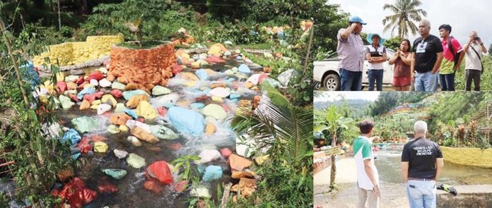 painted-rocks Negros Occidental Provincial Environment and Natural Resources Officer Joan Nathaniel Gerangaya (wearing black shirt) leads the inspection at a resort in Murcia where rocks and boulders are painted with bright colors. PENRO NEGROS OCCIDENTAL PHOTOS