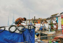 A resident uses plastic sacks and scrap wood as he strengthens a shanty to help make it withstand the storms in Baseco Community in Tondo, Manila. JONATHAN CELLONA/ABS-CBN NEWS FILE PHOTO