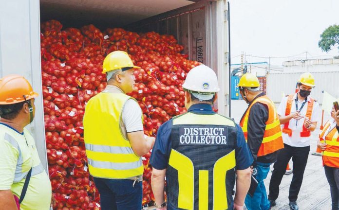smuggled_onions_resized_resized Bureau of Customs agents check smuggled onions from China at the Port of Manila on Thursday, Oct. 3, 2024. The agency seized around P2 million worth of onions. BUREAU OF CUSTOMS PHOTO