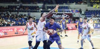 TNT Tropang Giga’s Henry Galinato tries to score against the defense of Rain or Shine Elasto Painters’ Aaron Fuller. PBA PHOTO