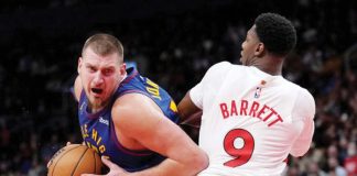 Denver Nuggets’ Nikola Jokic wards off the defense of Toronto Raptors' RJ Barrett. AP