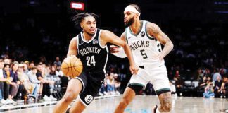 Brooklyn Nets guard Cameron Thomas (24) drives to the basket against Milwaukee Bucks guard Gary Trent Jr. (5). PHOTO COURTESY OF NOAH K. MURRAY/AP