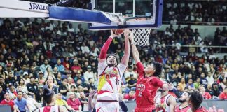 San Miguel Beermen’s June Mar Fajardo scores against the defense of Barangay Ginebra San Miguel Kings’ Ralph Cu. PBA PHOTO