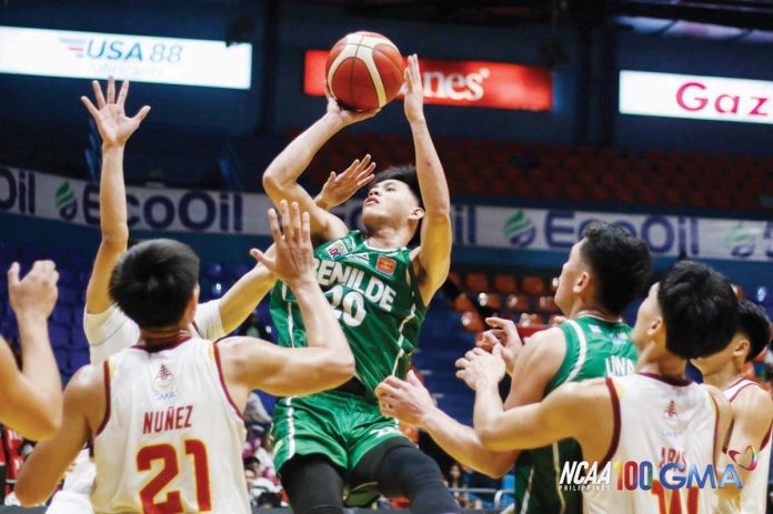 College of St. Benilde Blazers’ Justine Sanchez attempts a shot from close range. PHOTO COURTESY OF NCAA/GMA SPORTS