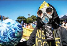Climate deal too little too late, poorer nations say A climate protester wearing a gas mask and protective clothing holds a model of planet earth. The mask reads in captial letters: NO MORE COAL OIL GAS FUELLING CLIMATE CHANGE. GETTY IMAGES